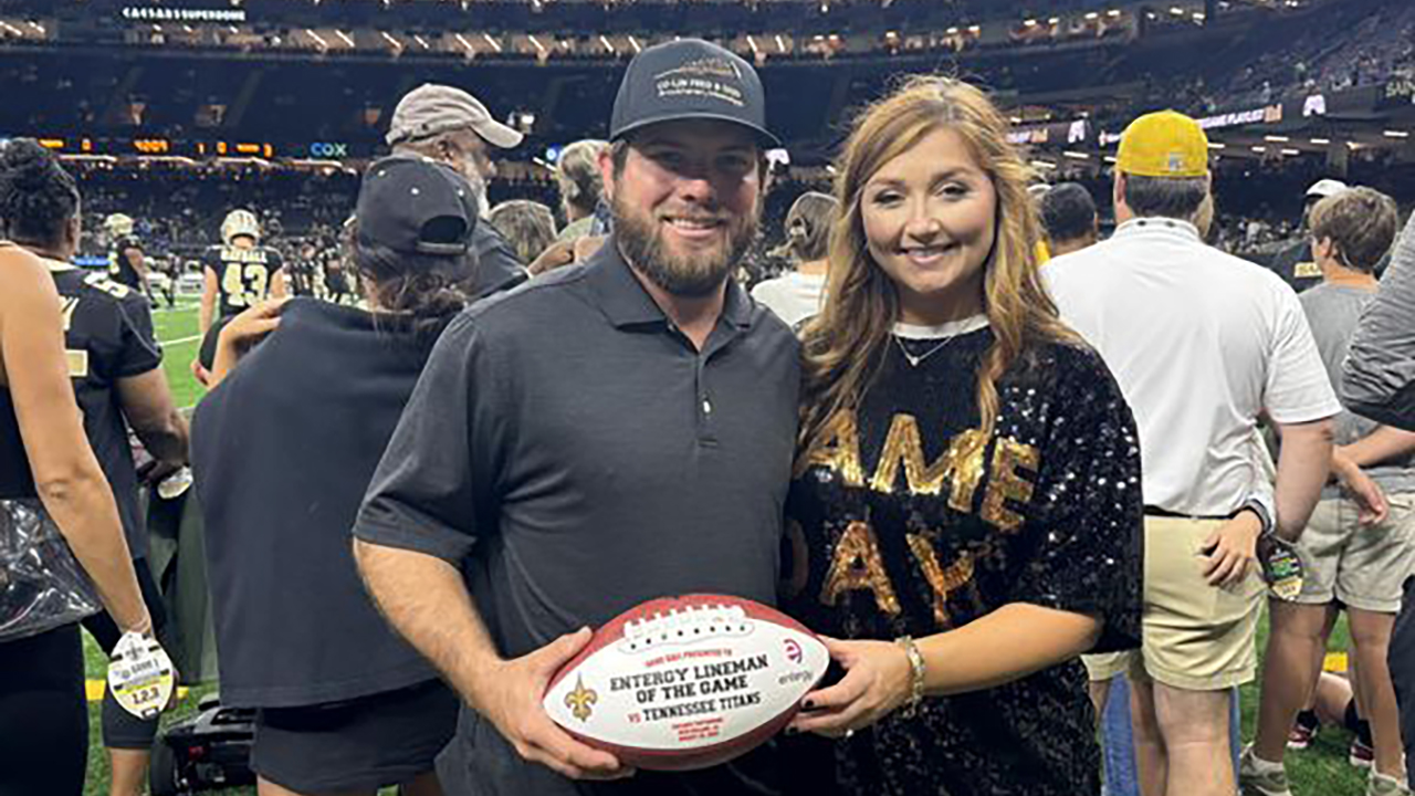 Entergy Lineman of the Game Jake Knight (left) and his wife, Harley, get ready to cheer on the Saints as they take on the Titans at a game held recently at the Superdome.